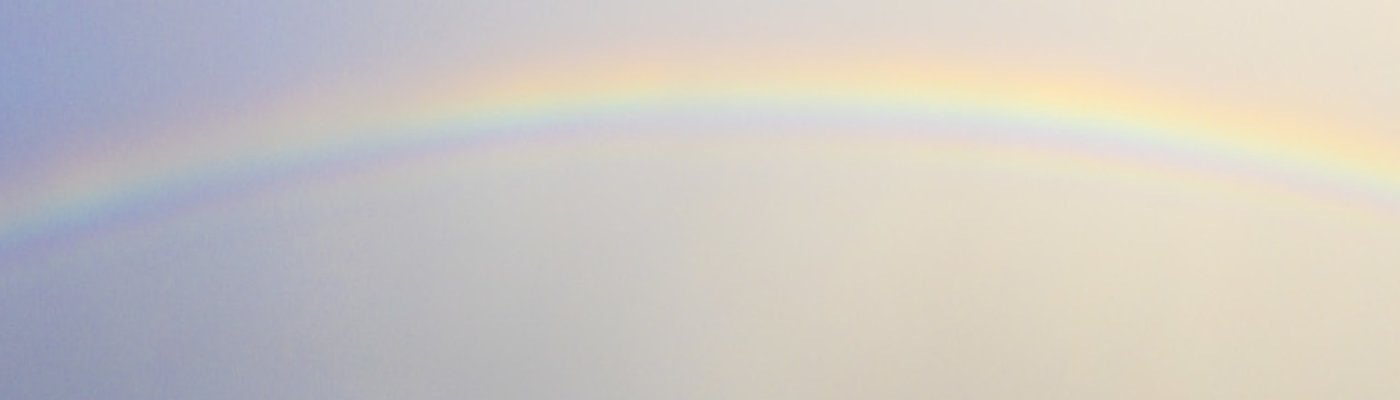 A vibrant rainbow over a coastal landscape, symbolizing hope, beauty, and the possibility of joy after storms.